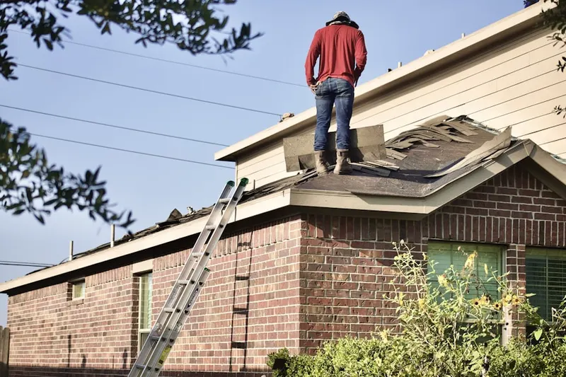 Professional roofer working on a residential roof in West Bear Valley